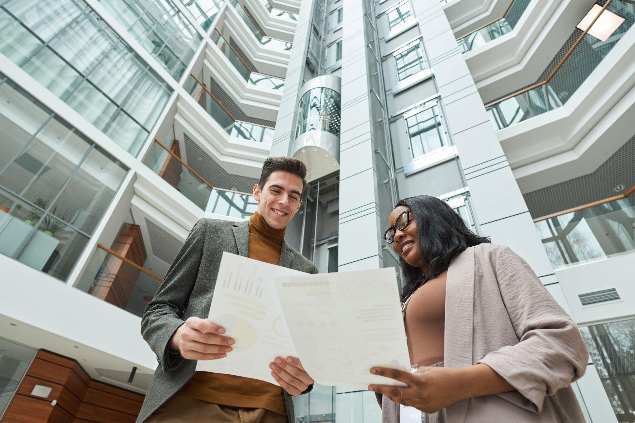 Apartment locators reviewing floor plans inside a modern Dallas building.