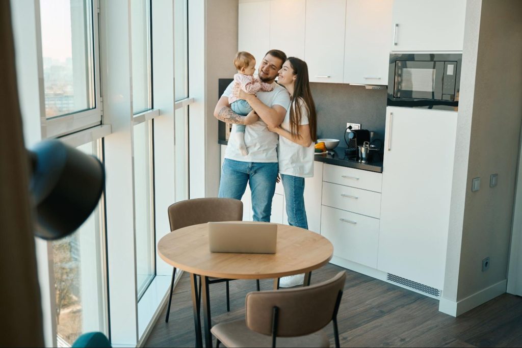 Family in a bright high-rise apartment in downtown Dallas, highlighting living in downtown Dallas safety and secure buildings.