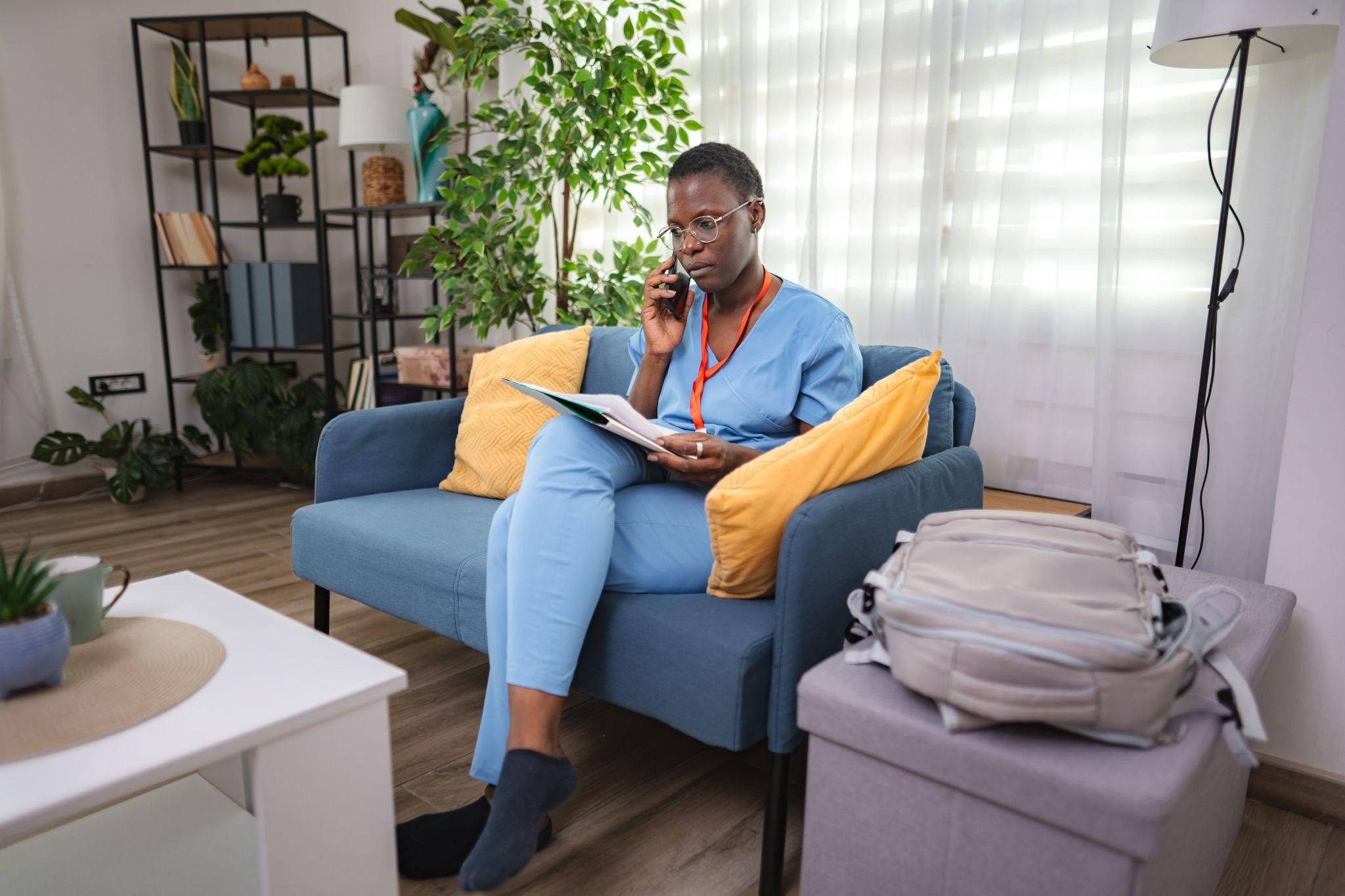 Healthcare professional relaxing at home near medical district Dallas apartments after a long shift.
